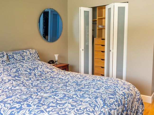 Bedroom with wood finished floors and baseboards | Image 23