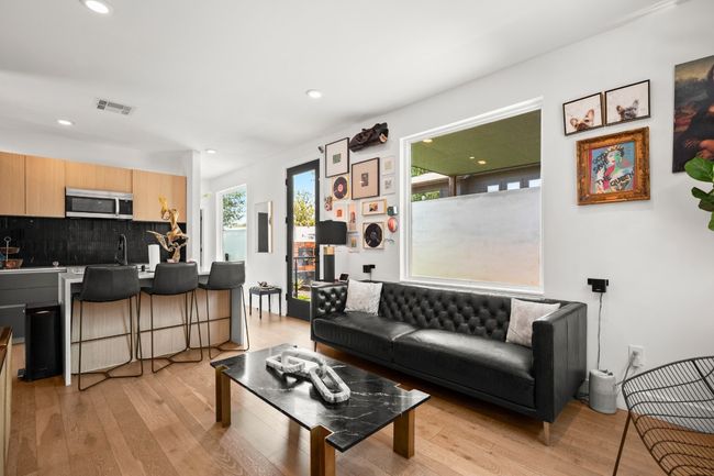 Living area with light wood-style floors and recessed lighting | Image 14