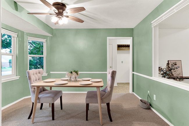 Carpeted dining area featuring a ceiling fan and baseboards | Image 7