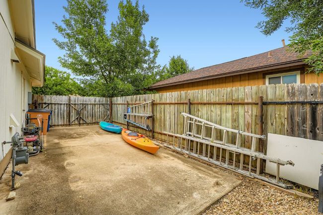 Fenced backyard with a patio area | Image 29