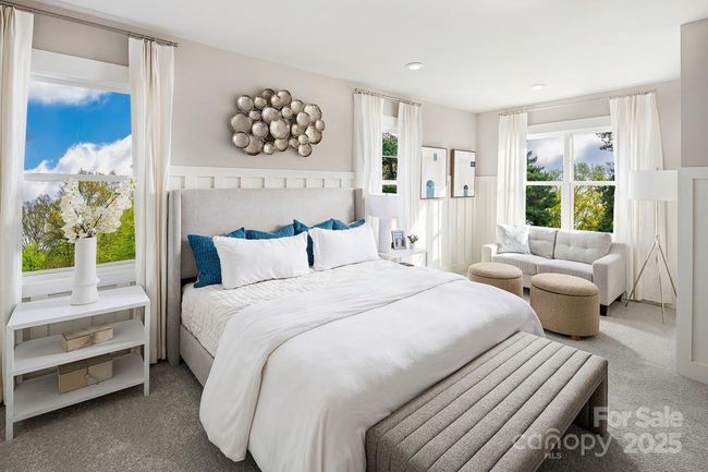 *This image is not of the actual home, but a photo of our model home, shown for representative purposes.* Spacious primary suite with abundant natural light and a cozy seating area, perfect for relaxation. | Image 8