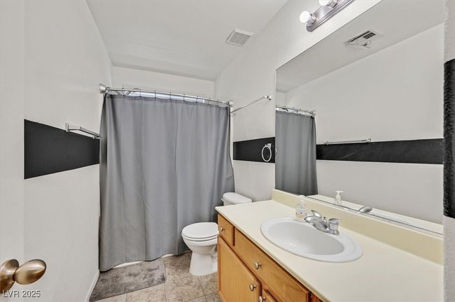 Full bath featuring toilet, vanity, and a shower with curtain | Image 21