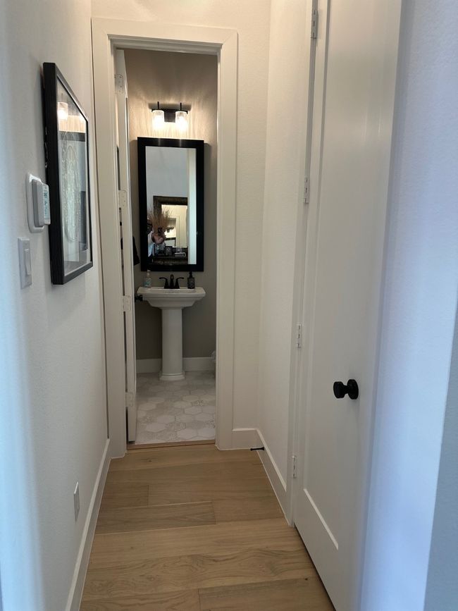 Hall featuring light wood-style flooring and baseboards | Image 6