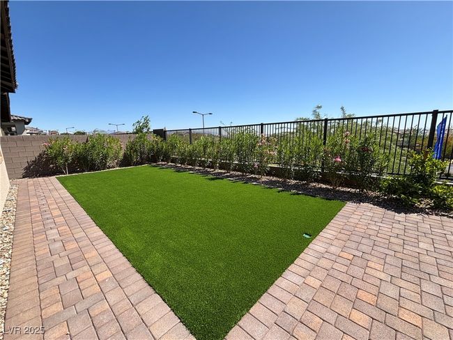 View of yard featuring a fenced backyard and a patio area | Image 39