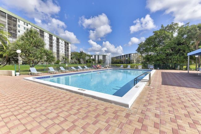 Clubhouse Pool Overlooks the Lake & Fountains. There is a Large Shaded area for your comfort as well. | Image 60