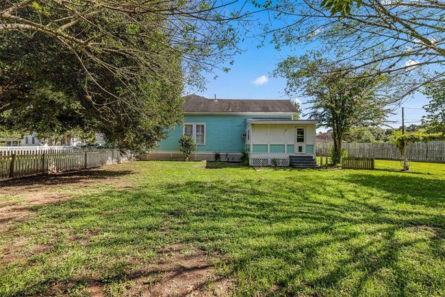 Fenced backyard with mud room/covered patio area. | Image 26