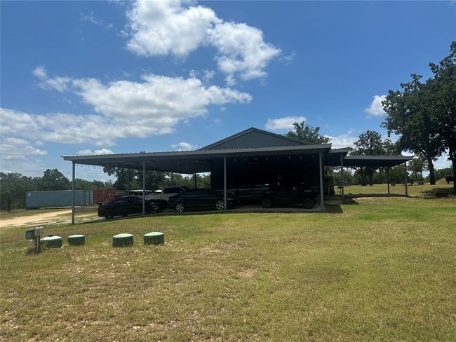 View of home's community featuring a yard and an attached carport | Image 18