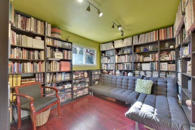 Sitting room featuring bookshelves, track lighting, and wood-type flooring | Image 17