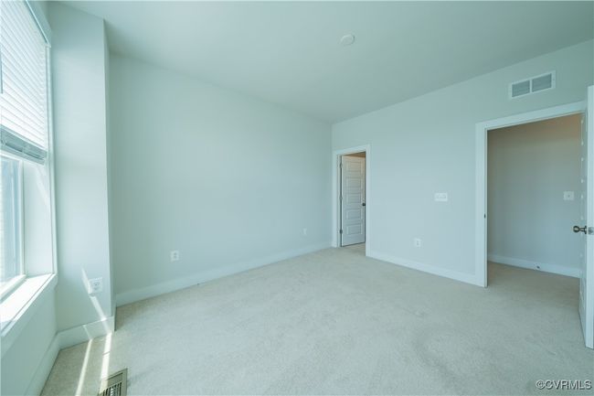 Unfurnished bedroom featuring light colored carpet and baseboards | Image 29