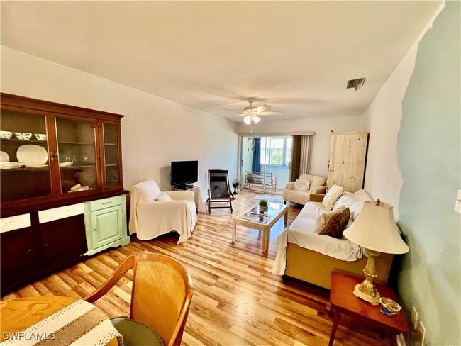 Living room with wood finished floors. | Image 9
