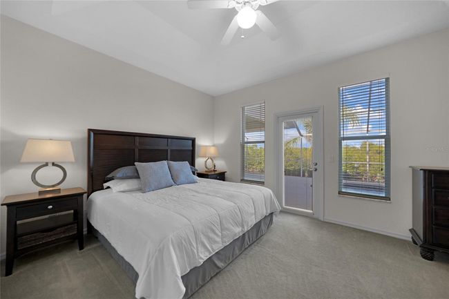 PRIMARY BEDROOM EN-SUITE WITH DOORWAY TO POOL AND LANAI | Image 27