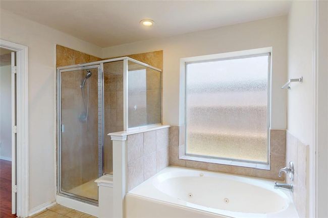 Primary bathroom has separate garden tub, and stand up shower. | Image 31