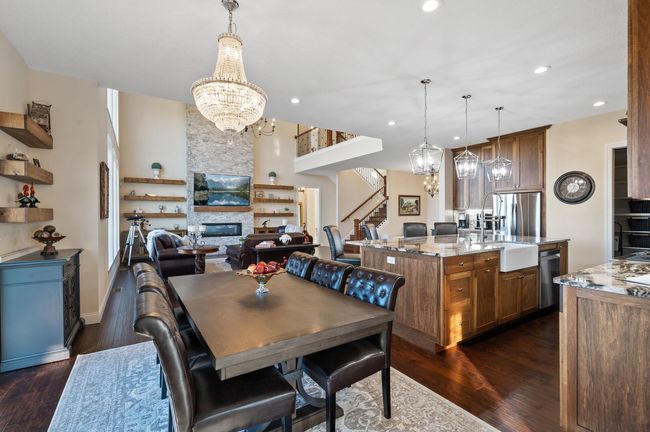 Adjacent to the kitchen, this inviting dining space features a stylish chandelier that adds a touch of elegance. With easy access to the outdoor deck, it's perfect for seamless indoor-outdoor entertaining and enjoying peaceful countryside views. | Image 8