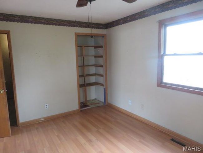 Unfurnished room with ceiling fan, a healthy amount of sunlight, and light hardwood / wood-style floors | Image 16