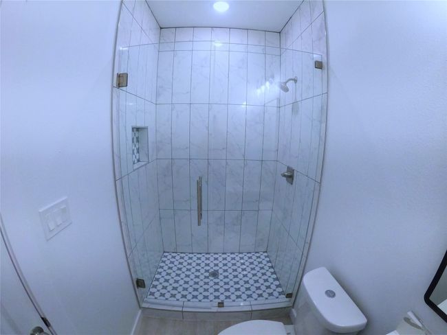 Bathroom featuring a stall shower and toilet | Image 13