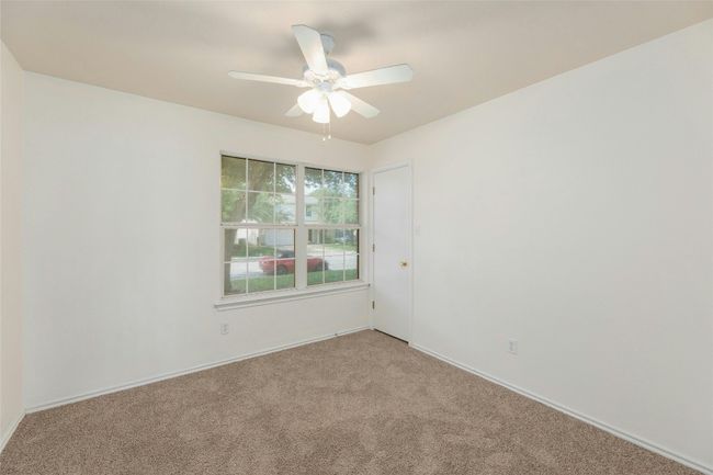 Spare room featuring a ceiling fan and light carpet | Image 15