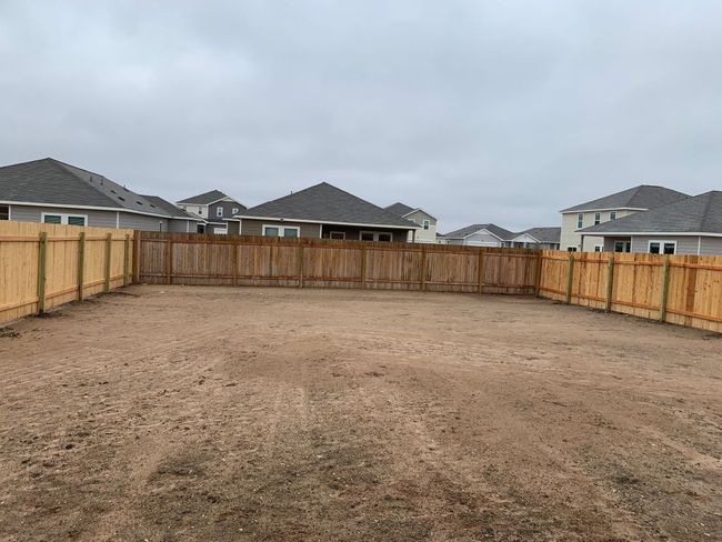 Fenced backyard with a residential view | Image 12