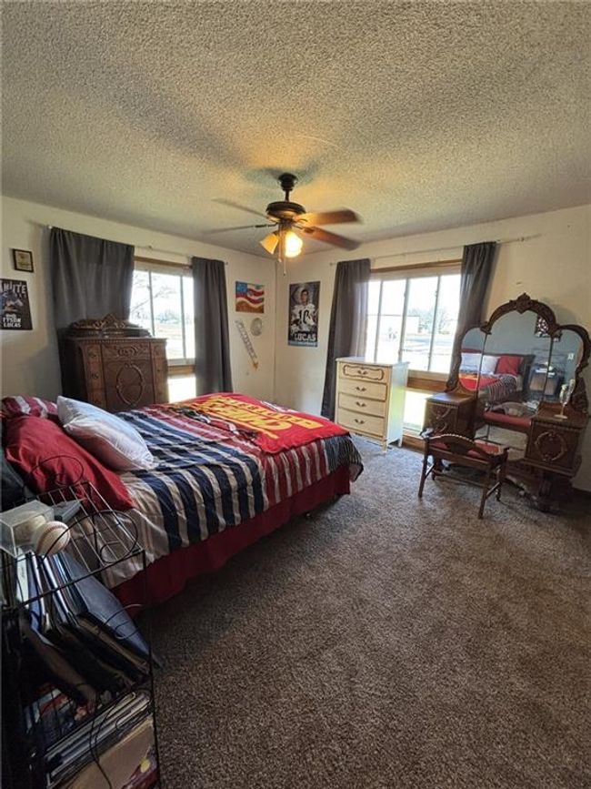 Bedroom 2 featuring screened windows, ceiling fan and roomy closet. | Image 12