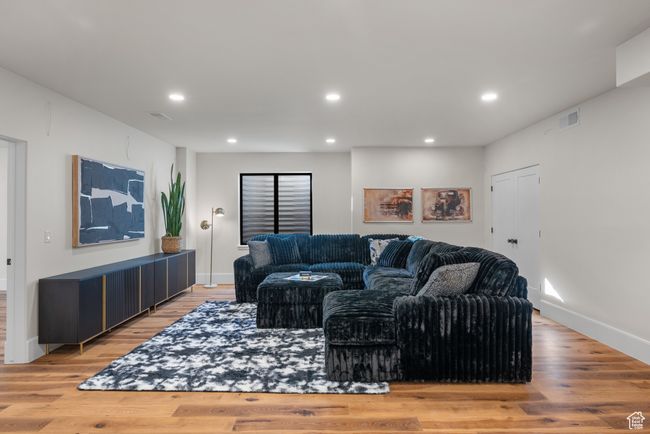 Living room with light wood-style flooring and recessed lighting | Image 54