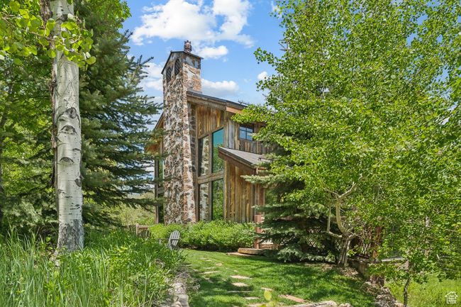 View of property exterior with a chimney | Image 55