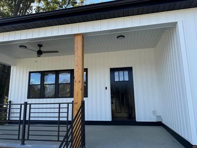 Doorway to property featuring a porch and ceiling fan | Image 3