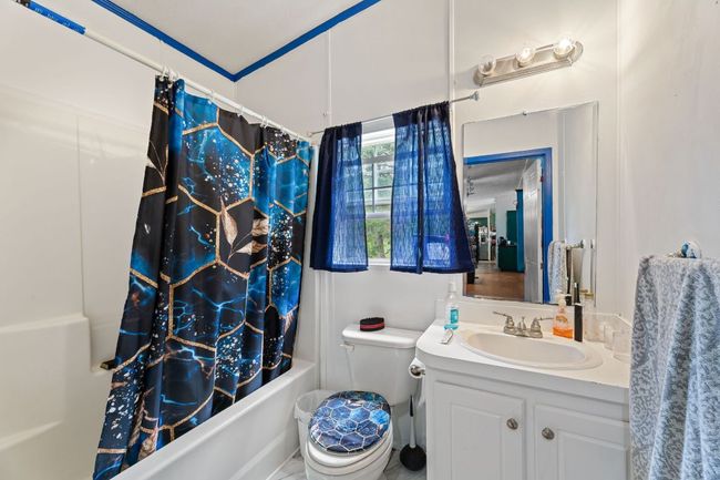 Full bathroom 2 featuring shower / bath combo with shower curtain, vanity, and toilet | Image 16