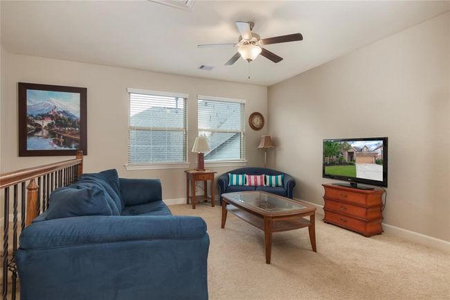 This spacious game room area located upstairs offers a private area for those staying upstairs. The large windows allow for a ton of natural light to flow in. | Image 33