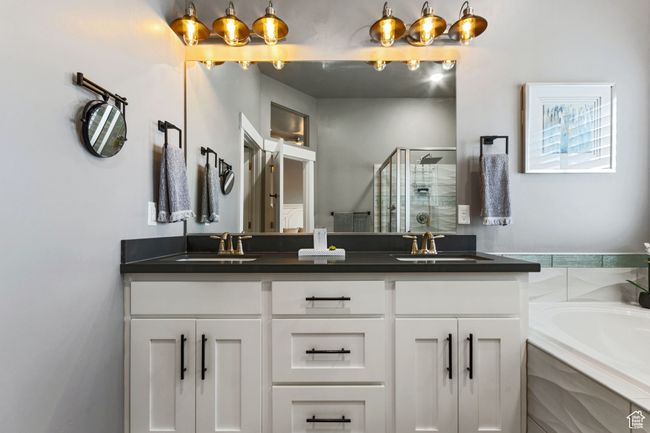 Full bath with a garden tub, a sink, double vanity, and a stall shower | Image 15