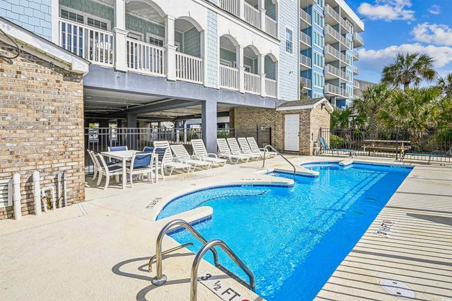 Community pool with a patio area | Image 37