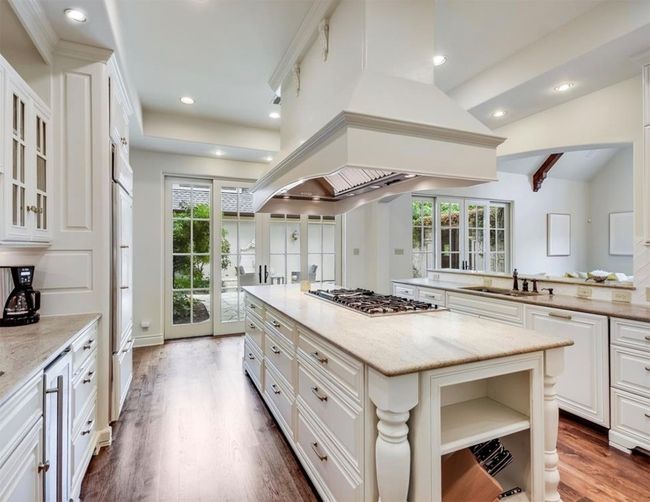 Kitchen featuring center island, build in appliances including gas range, ample cabinet space. | Image 12