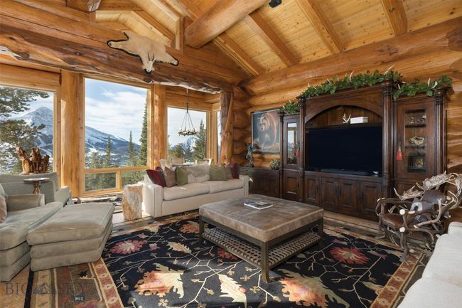 Main level great room with vaulted ceiling, vast windows with fantastic views and custom, built-in entertainment center. | Image 41