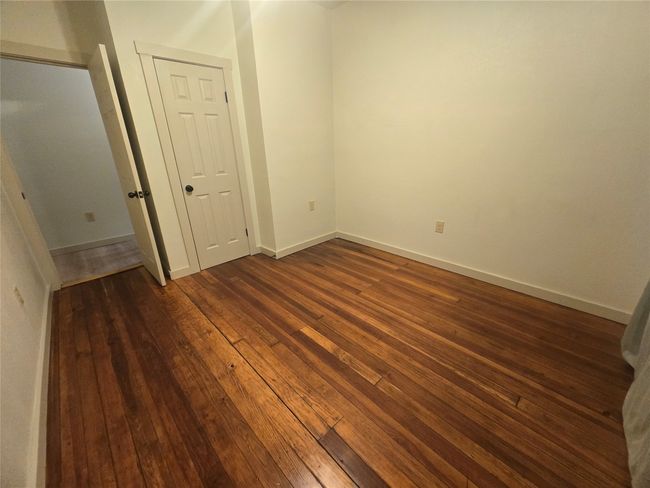 Unfurnished room featuring dark wood-style flooring and baseboards | Image 17