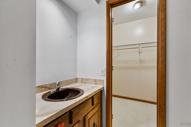 Sink and walk in closet in the primary bedroom! | Image 32