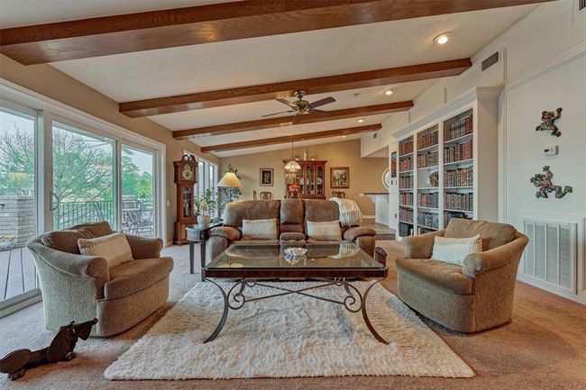 Built-in shelving offers both functional storage and a stylish space to display décor. Just beyond, the dining room and kitchen create a seamless flow for everyday living and entertaining. | Image 9