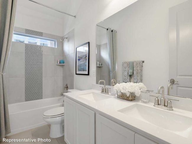 Bathroom featuring shower / washtub combination, a sink, double vanity, and toilet | Image 12