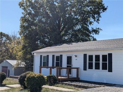 View of front facade featuring a shed and a wooden deck | Image 1