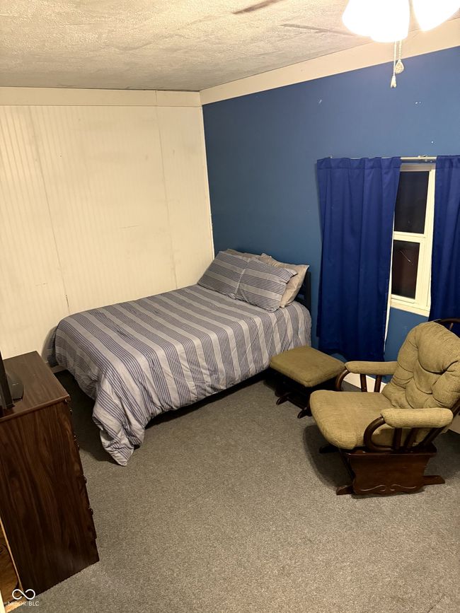 carpeted bedroom featuring a textured ceiling | Image 18