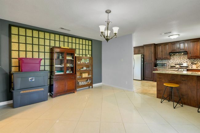 Dining room provides easy access to the kitchen and leads into the breakfast nook as well. | Image 8