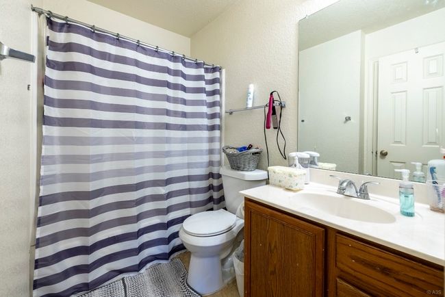Full bathroom featuring vanity, a textured wall, and a shower with shower curtain | Image 14