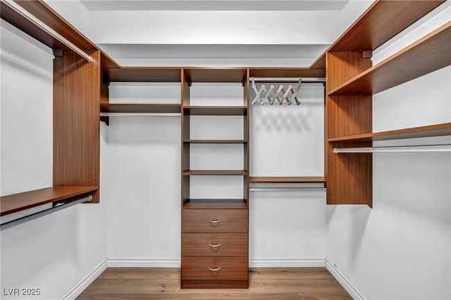 Walk in closet featuring wood finished floors | Image 11