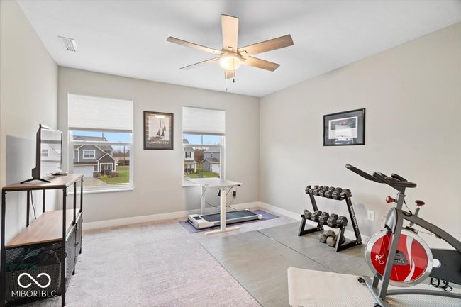 exercise room with a ceiling fan and baseboards | Image 28