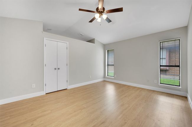 Unfurnished room featuring a ceiling fan, light wood-type flooring, and lofted ceiling | Image 13
