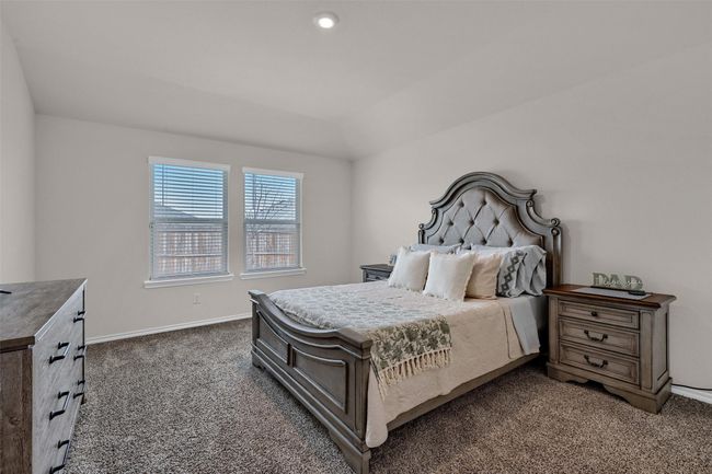 Bedroom featuring dark carpet and baseboards | Image 16