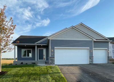 9853 32nd St NE- Home is ready for move-in! Highlights include a spacious concrete front porch, Pella windows, stone accents, & an unfinished lower level ready for future finish including future family room, bath, bedrooms 4 & 5, bath, & storage. | Image 1