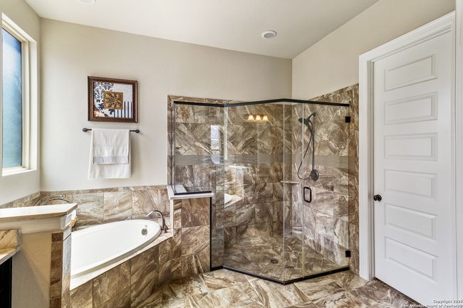 Elegant primary bathroom featuring a spa-like ambi | Image 25