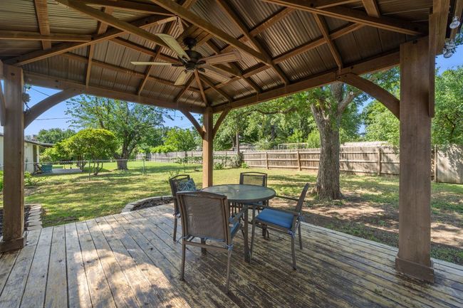 The backyard is HUGE and has a covered back patio perfect for dining al fresco! | Image 30