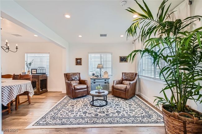 Living area with plenty of natural light, light wood-style flooring, baseboards, and recessed lighting | Image 15