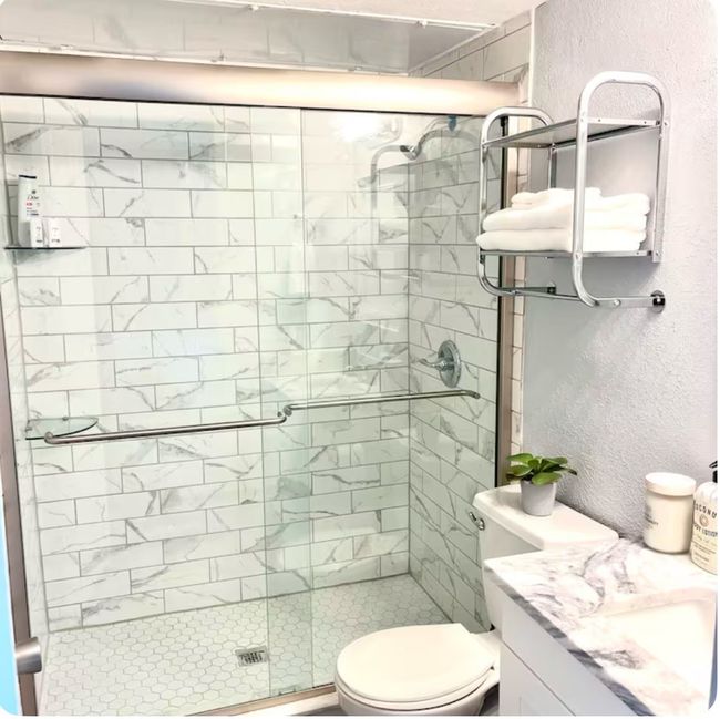 Bathroom with vanity, a shower with shower door, and toilet | Image 12