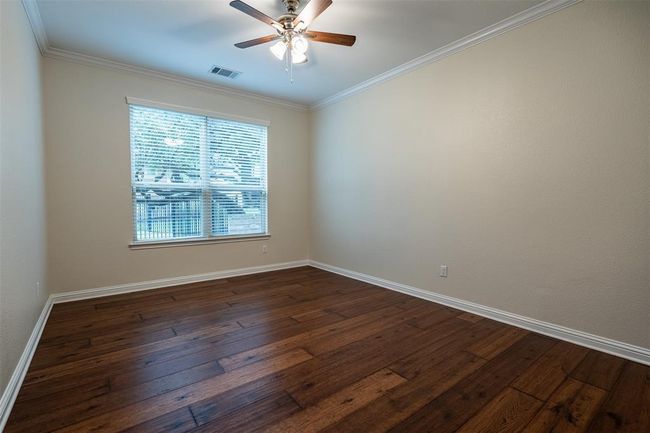 Unfurnished room featuring dark wood-style floors, ceiling fan, and crown molding | Image 14