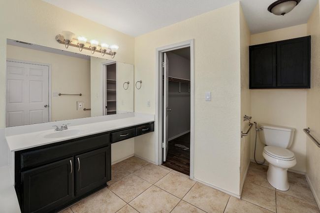 Full bathroom with vanity, tile patterned floors, and a spacious closet | Image 18